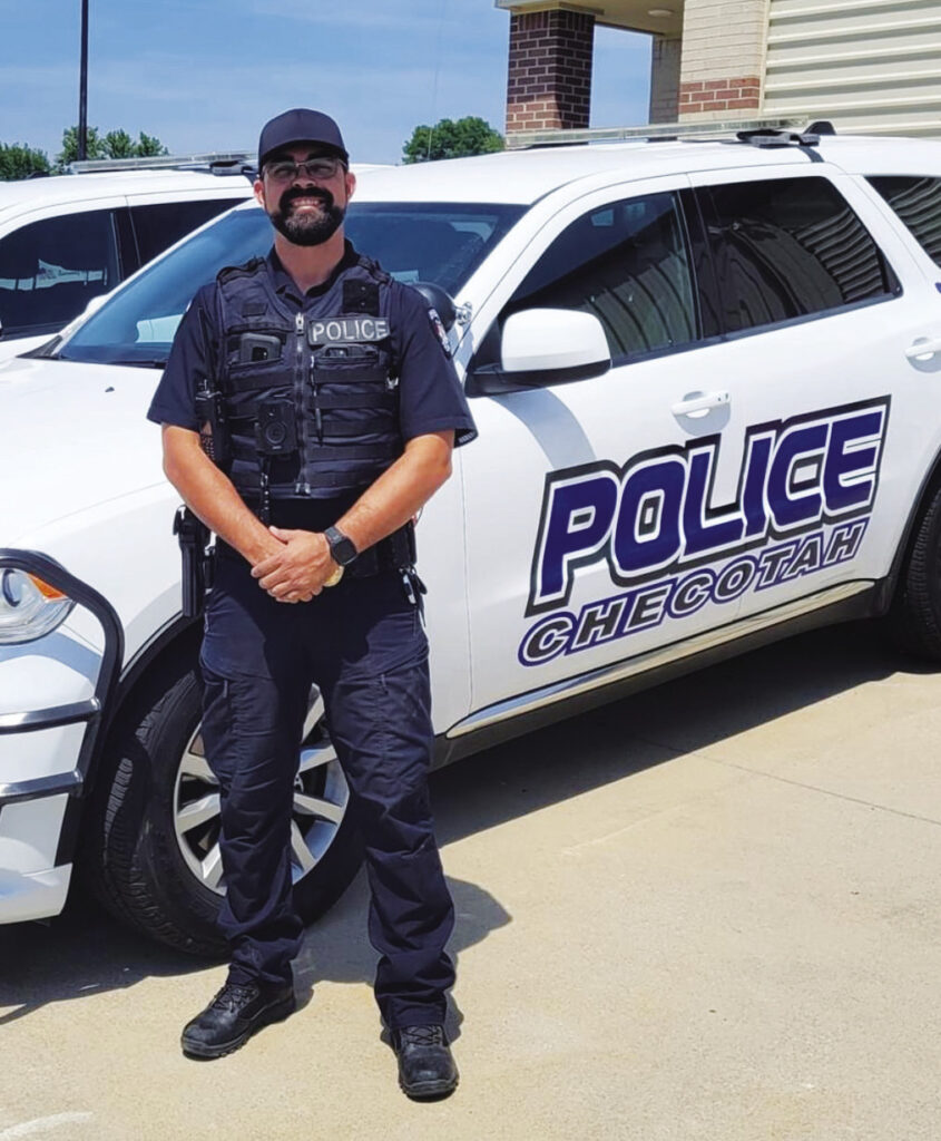 Officer Ryan Goad shows off one of the new police vehicles of the
